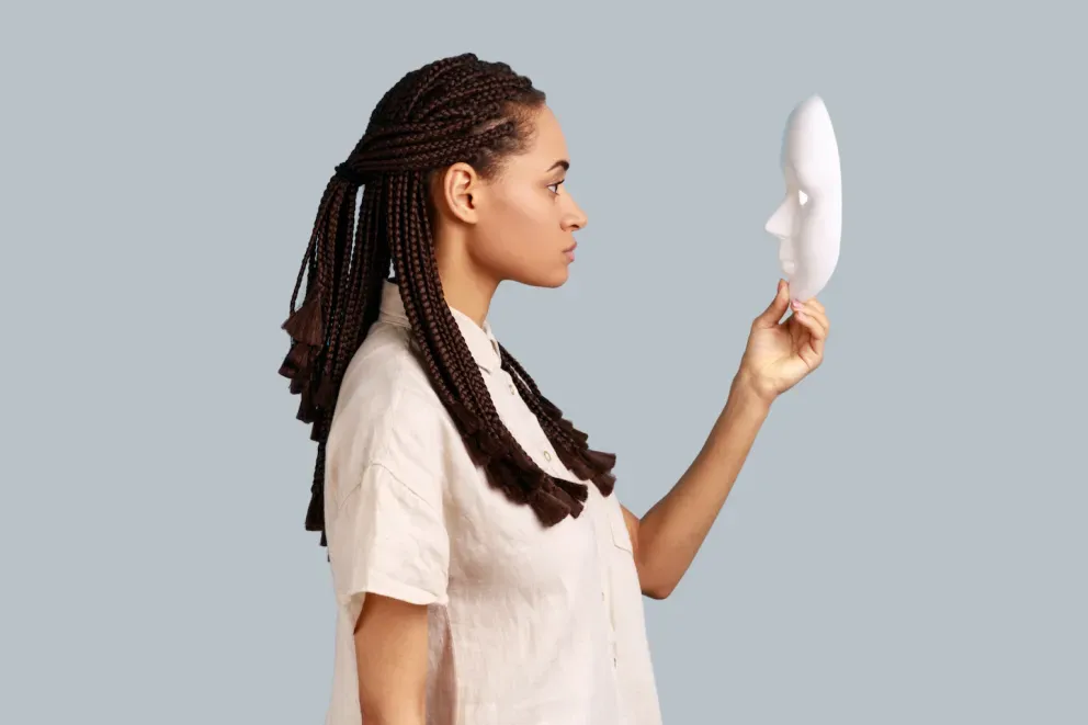 Woman looking at mask Woman looking at mask
