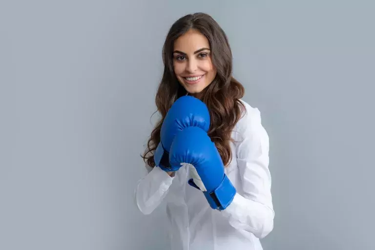 smiling woman with boxing gloves on