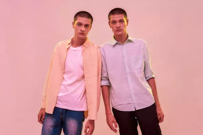 twin men leaning on each other