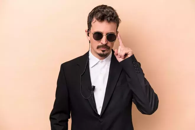 undercover security person with sunglasses and ear piece 