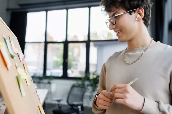 business person working out ideas on post it notes