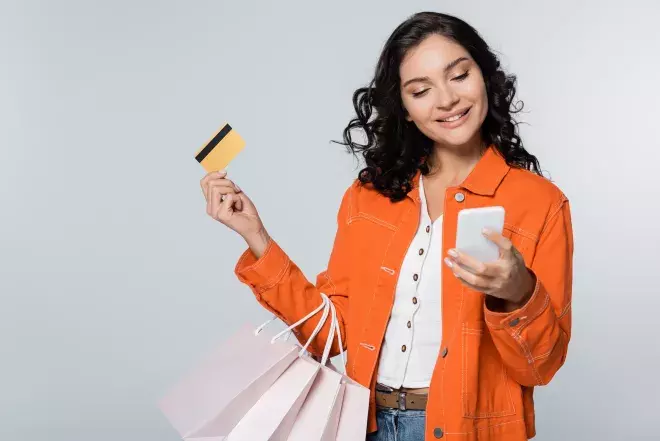 Woman with phone card and bags