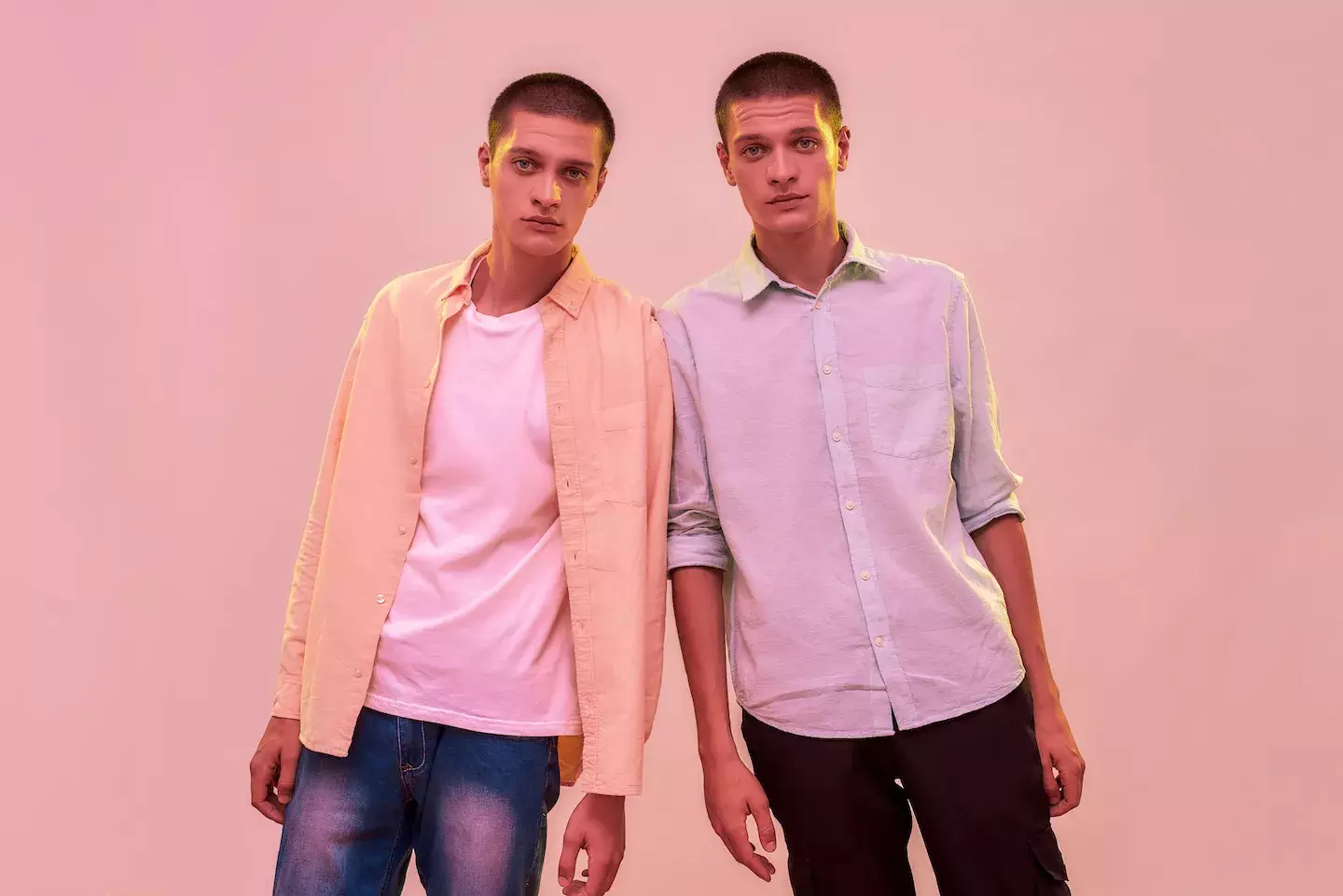 twin men leaning on each other