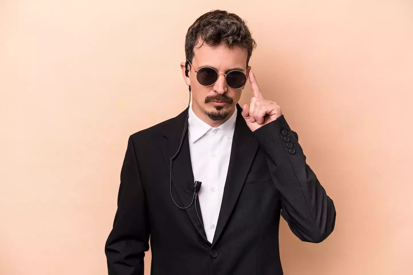 undercover security person with sunglasses and ear piece 