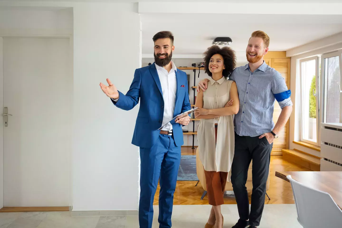 couple looking at new home with realtor