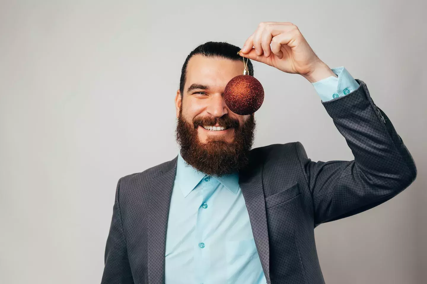smiling man holding ornament up 