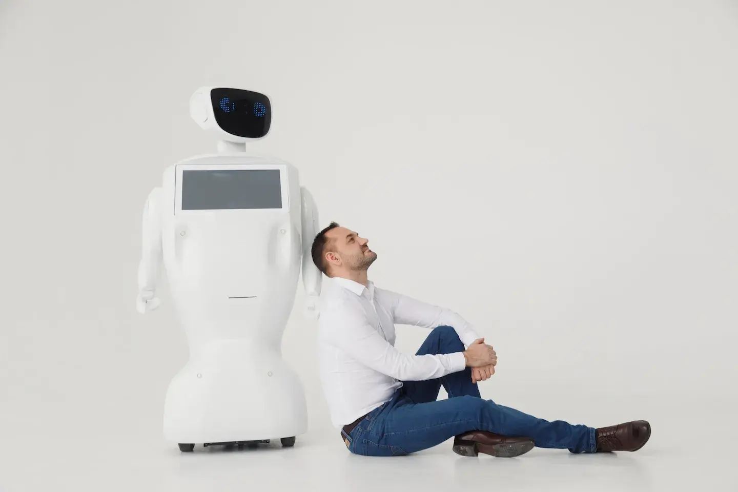 man leaning on robot thinking