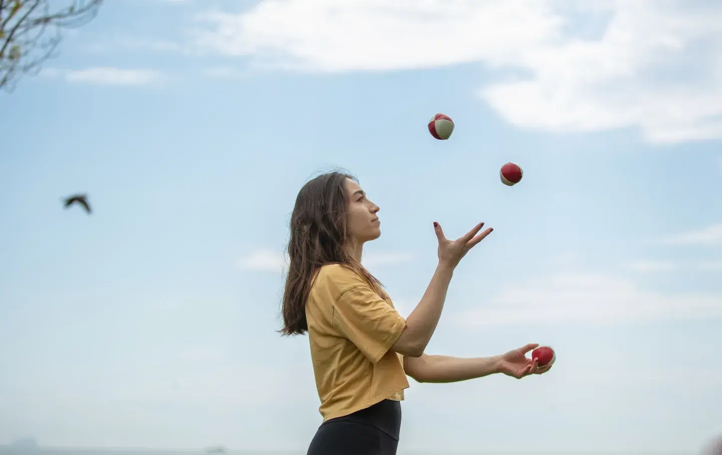 woman focused juggling outdoors