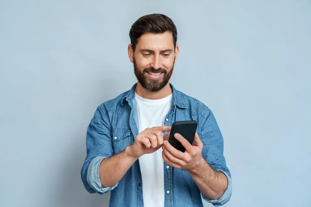 Man using phone and smiling