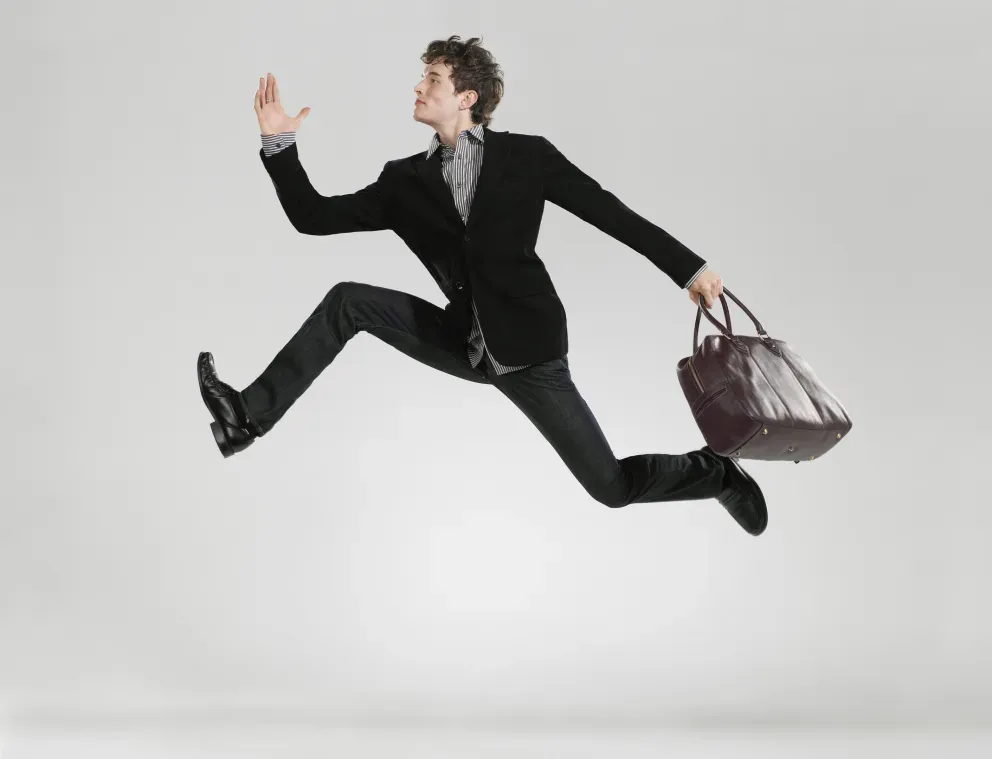 man jumping in the air holding a briefcase