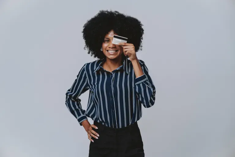 person covering one eye with a credit card