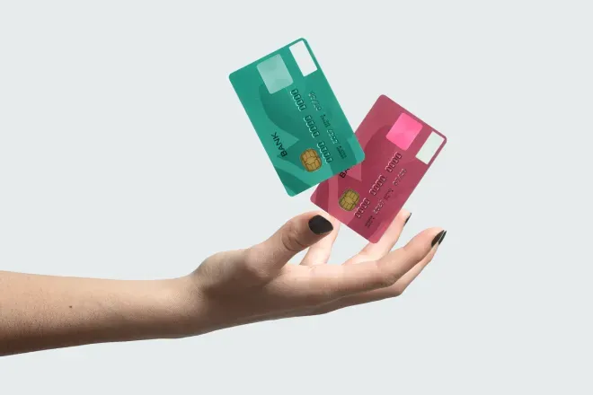 person holding credit cards