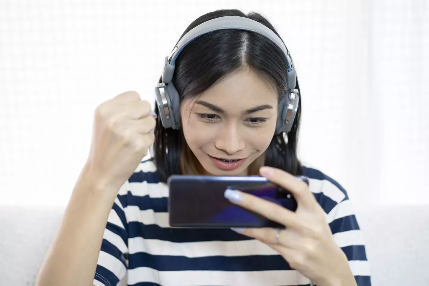 Mulher no telefone com fones de ouvido ligados
