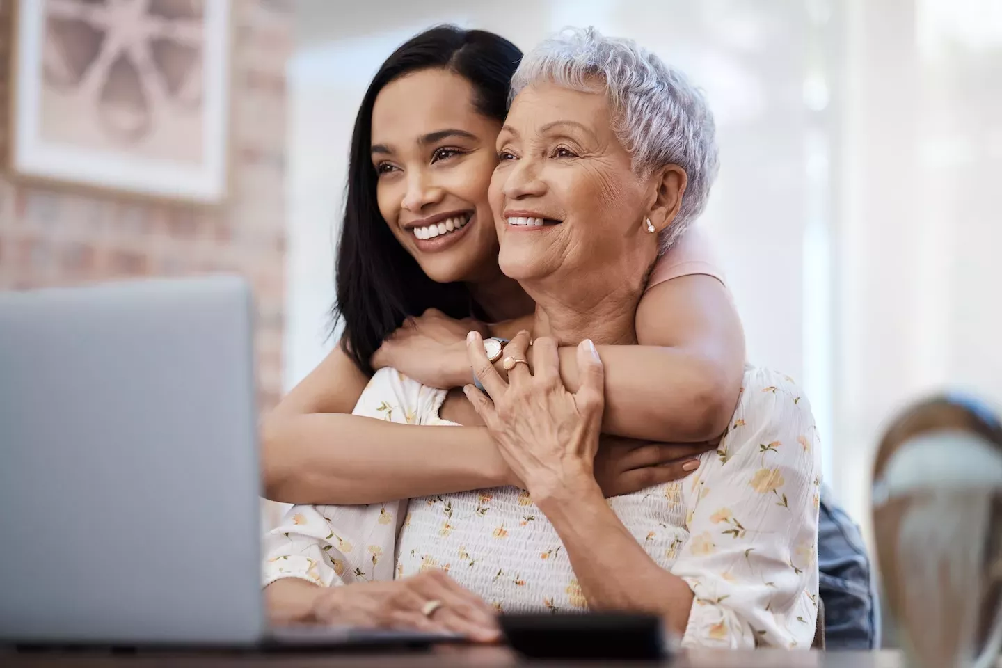 Women smiling looking at laptop