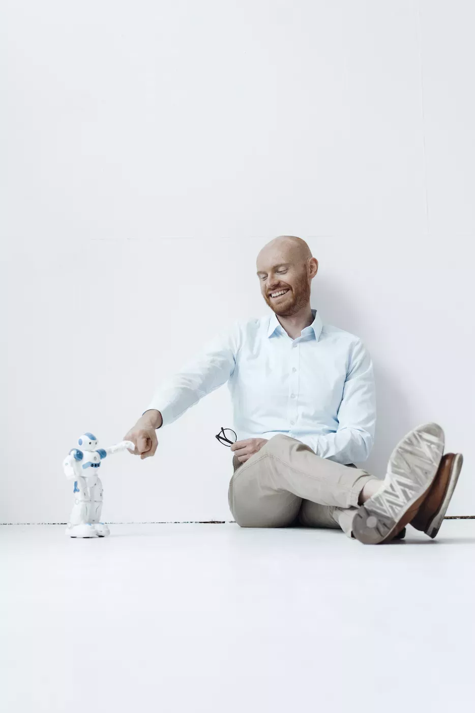 Man giving robot a fist bump