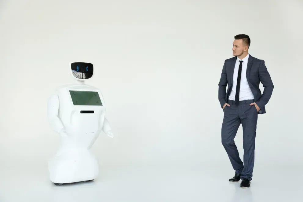 business man looking across room at AI robot