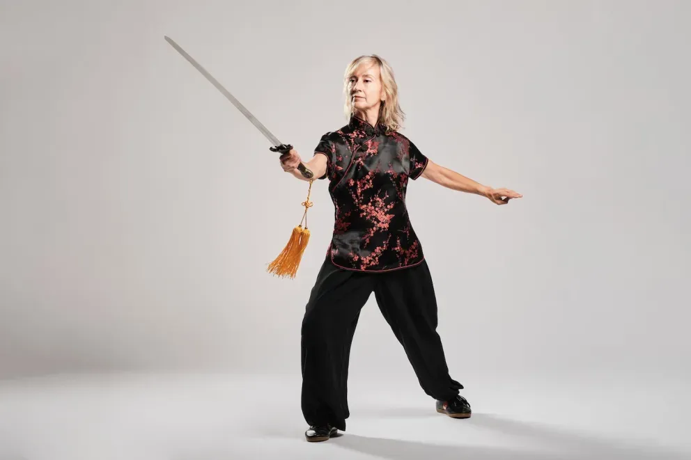 woman practicing Tai Chin with sword