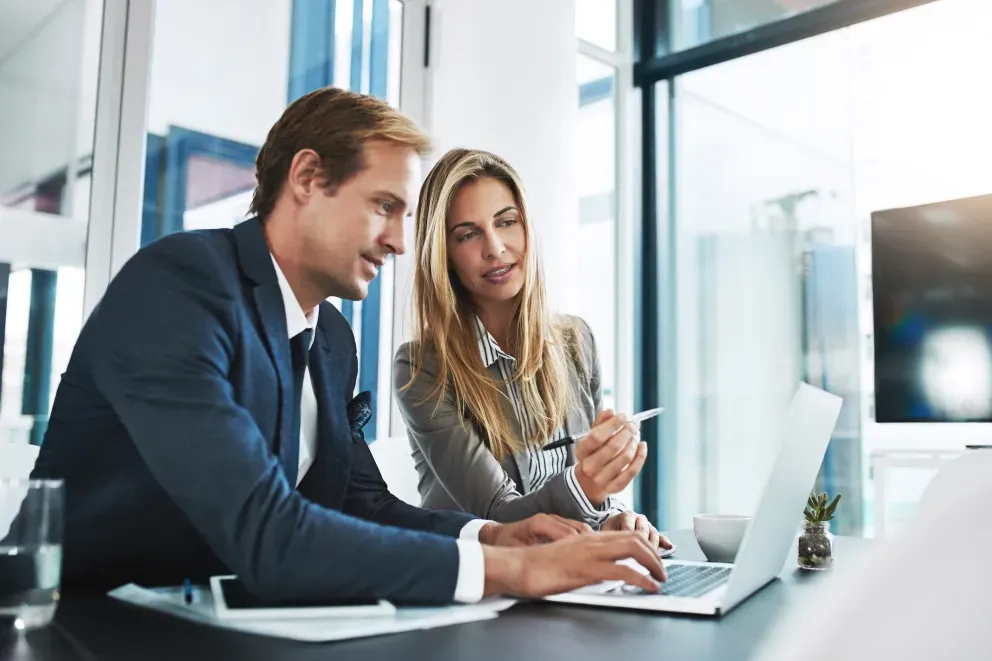 Business man and woman on laptop