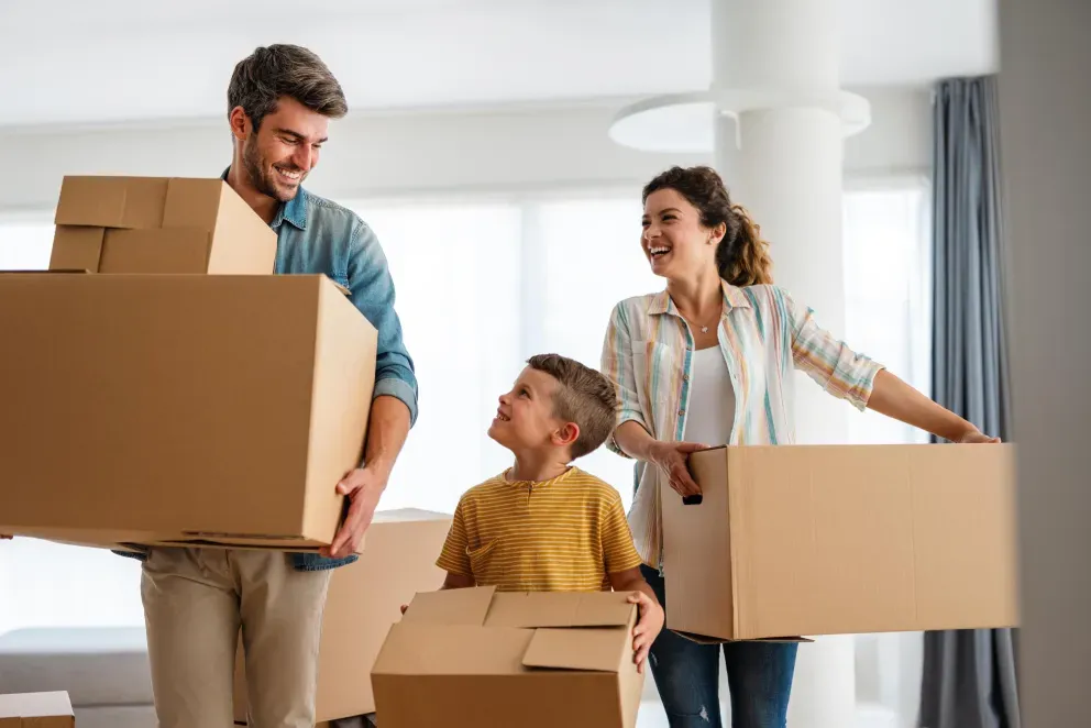 A family moving with boxes in hands.
