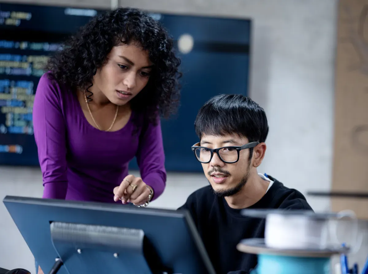 Woman and man student looking at computer screen Woman and man student looking at computer screen
