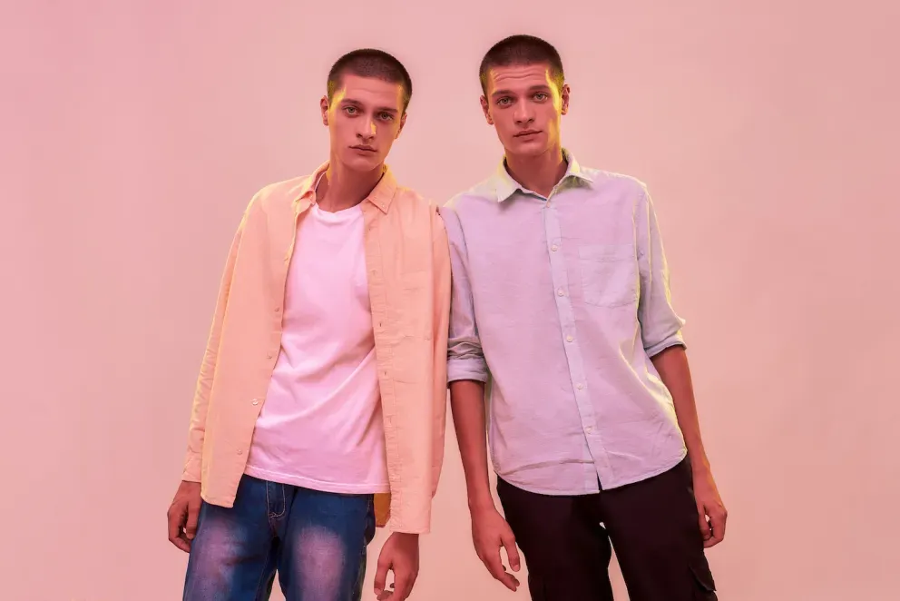 twin men leaning on each other