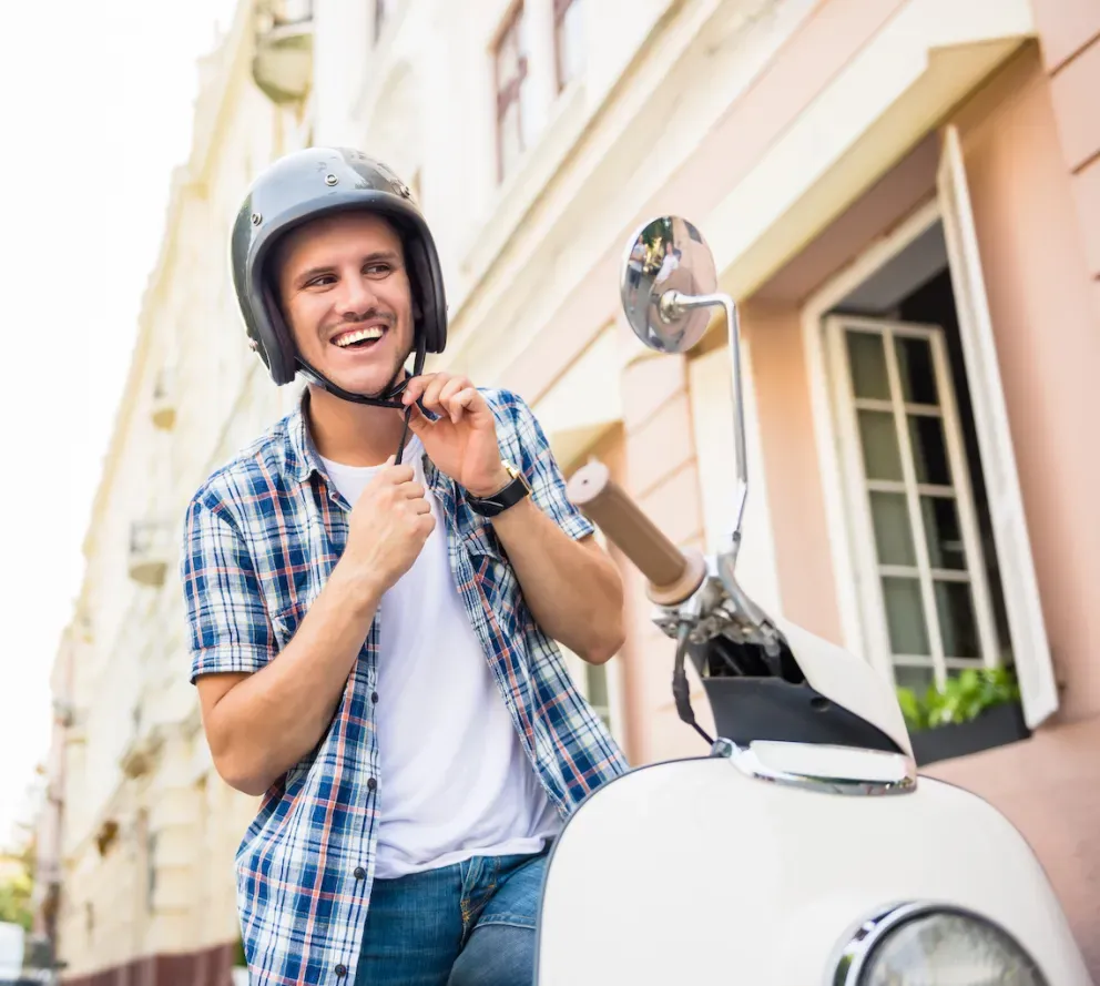 vespa rider putting helmet on