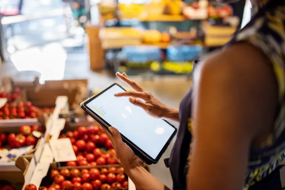 Grocer in grocery store with tablet Grocer in grocery store with tablet