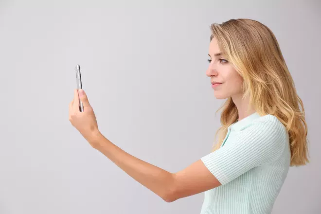 Woman using facial recognition technology