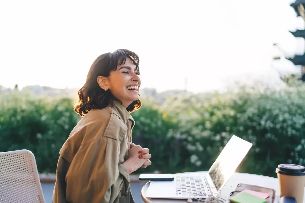 person sitting outside at computer