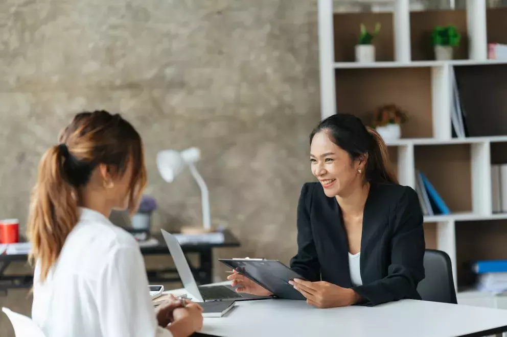 people talking at a desk