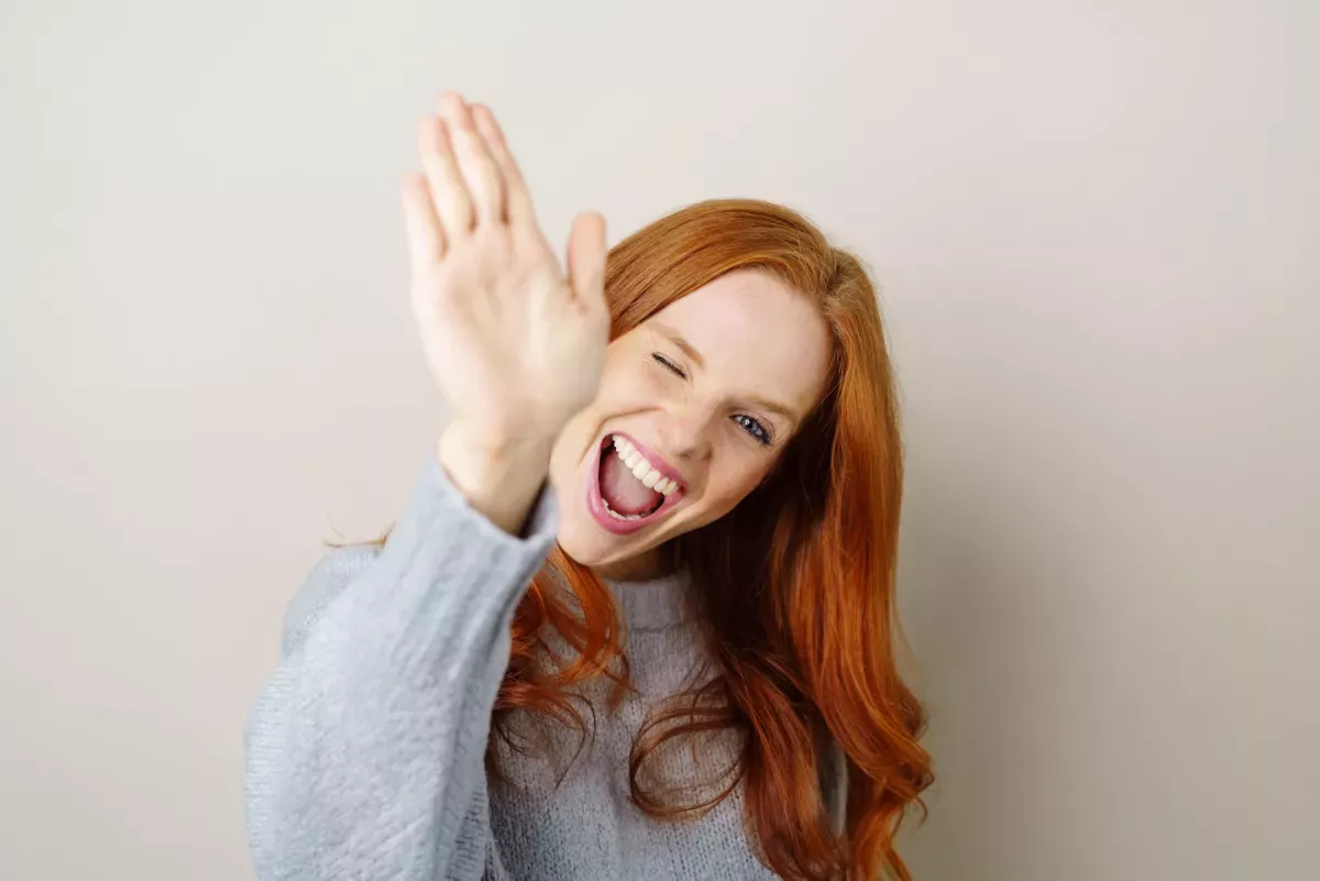 AdobeStock_168727454.jpeg Woman giving a high five