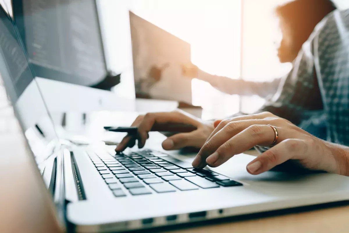AdobeStock_252358385.jpeg close up of person using laptop