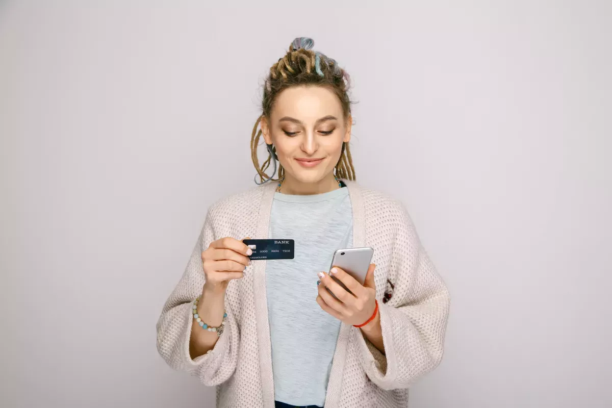 AdobeStock_267463635.jpeg Woman paying a bill on her phone