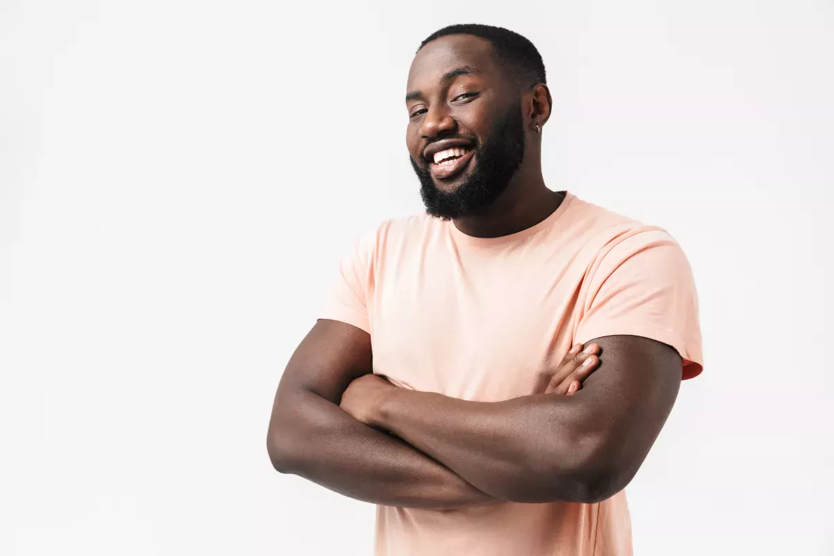AdobeStock_269014176.jpeg man smiling with arms crossed