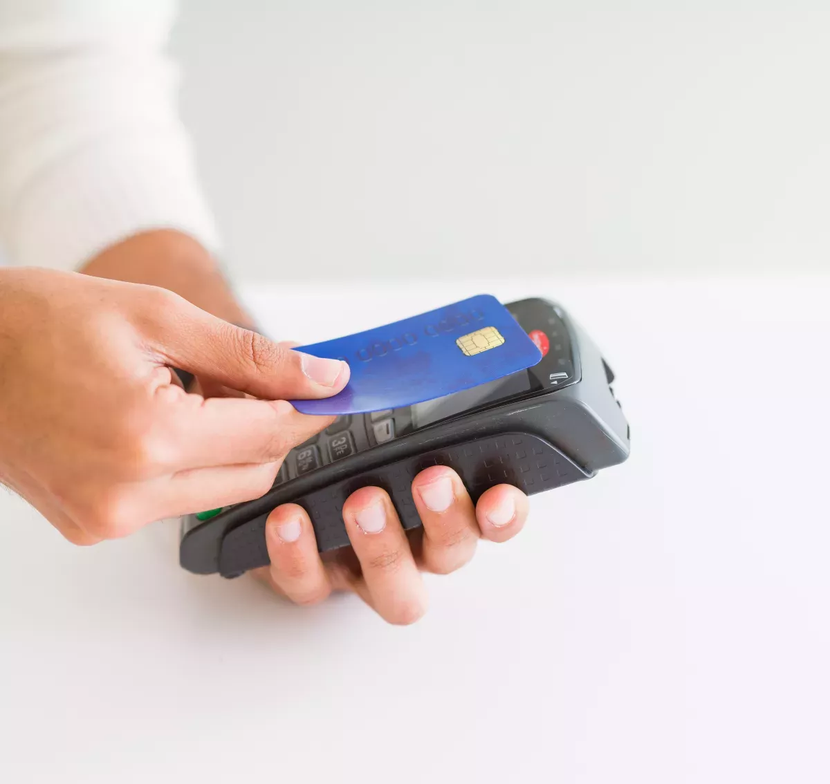 AdobeStock_297288480.jpeg Person paying with a debit card