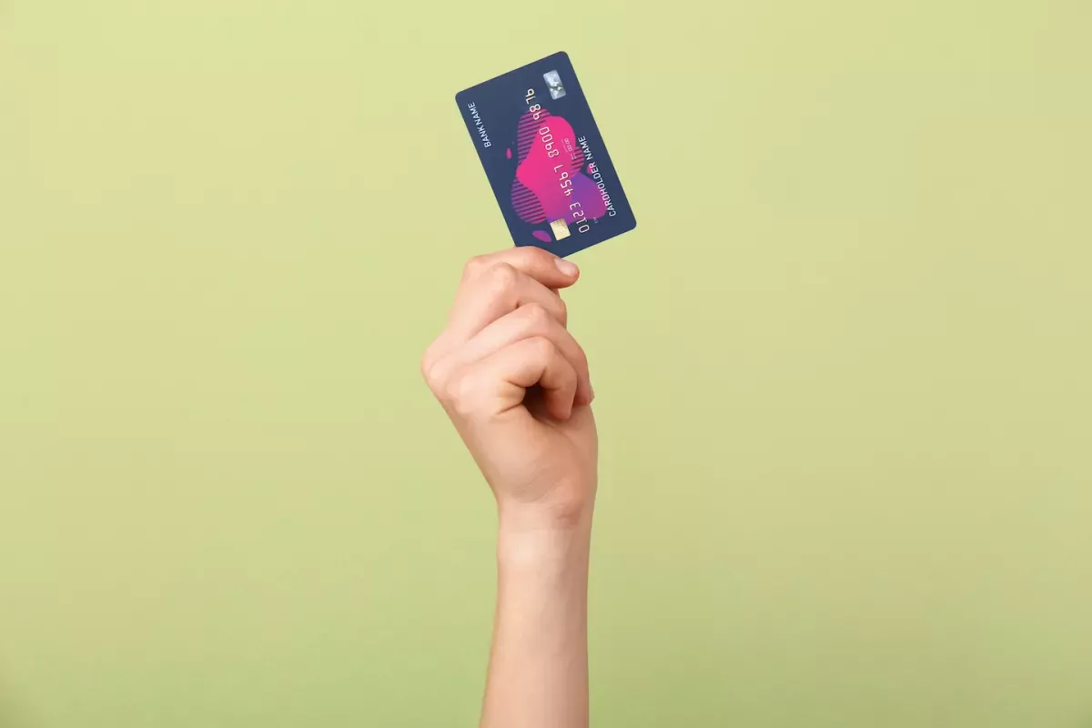 AdobeStock_324116272.jpeg Hand holding a credit card