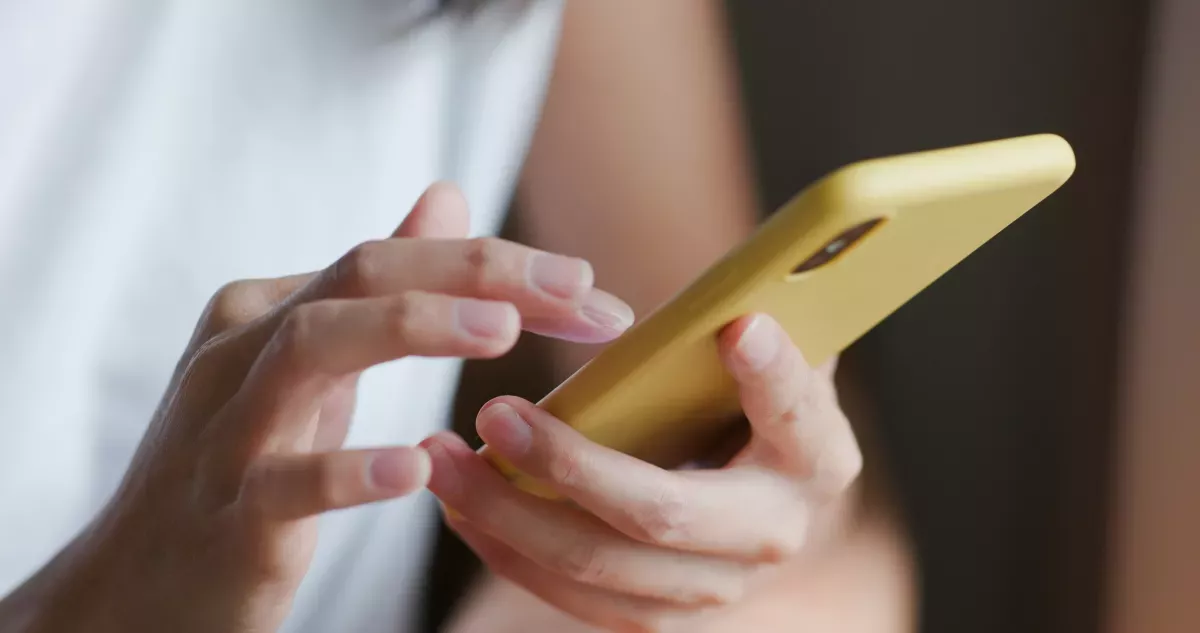 AdobeStock_364039326_Collections & Recovery close up of person using cell phone