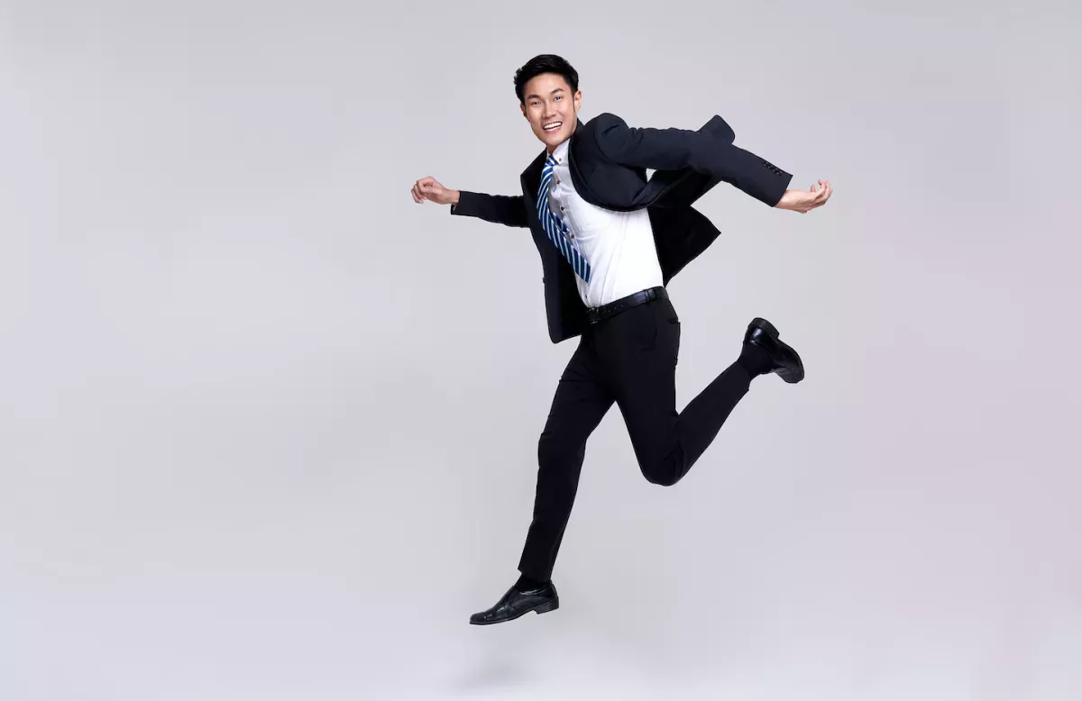 Man in a suit jumping