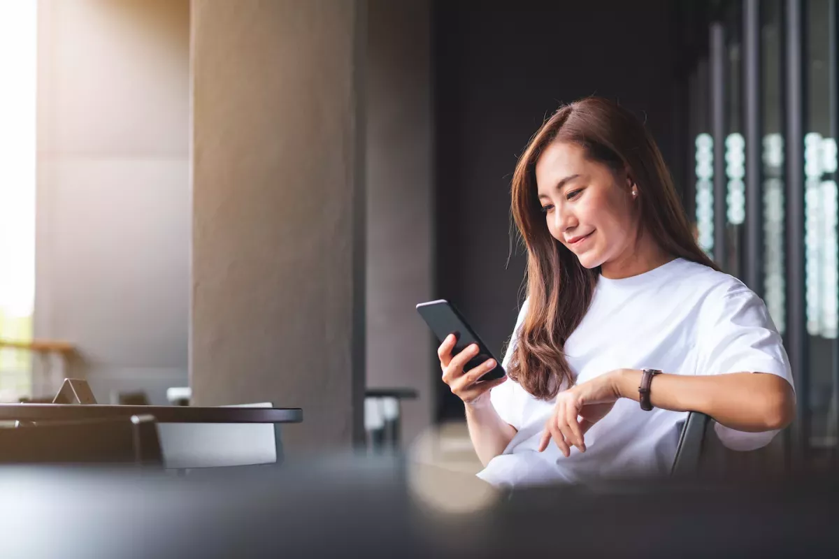 AdobeStock_445109808.jpeg Woman looking at phone