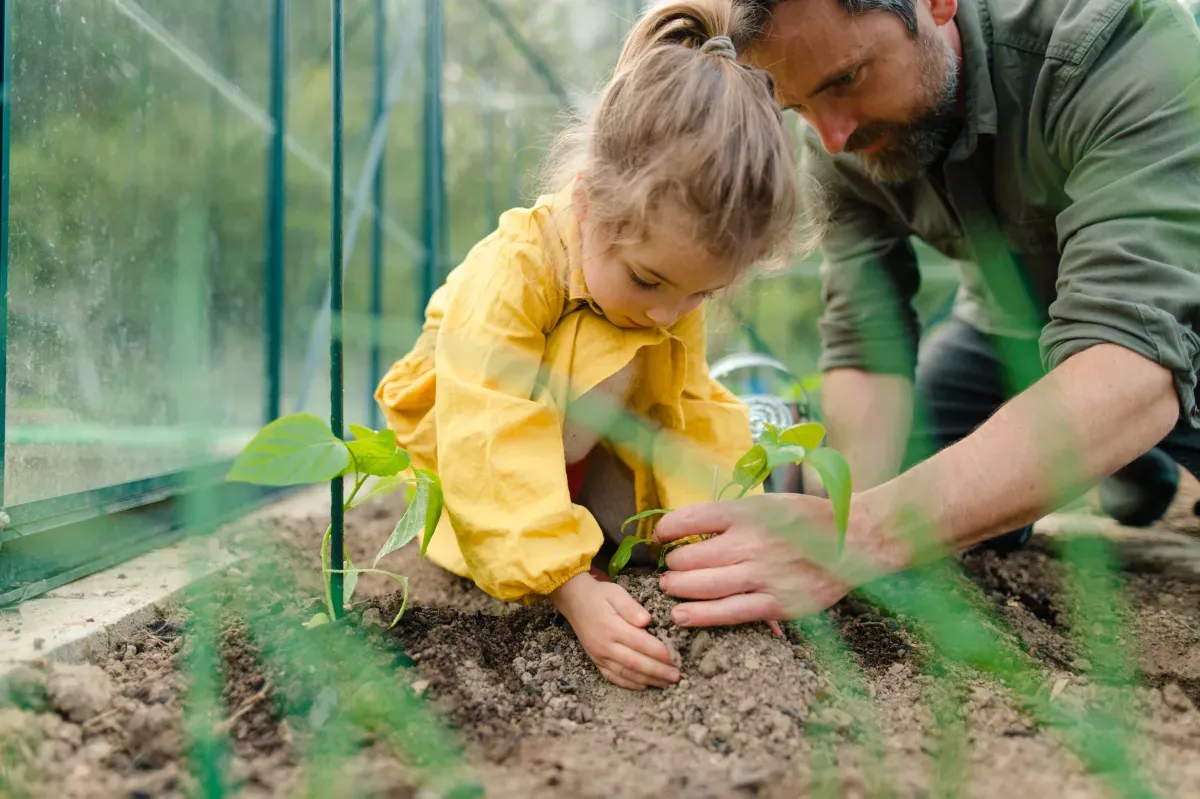 AdobeStock_508131910_Nurture & Manage close up of father and young daughter gardening together