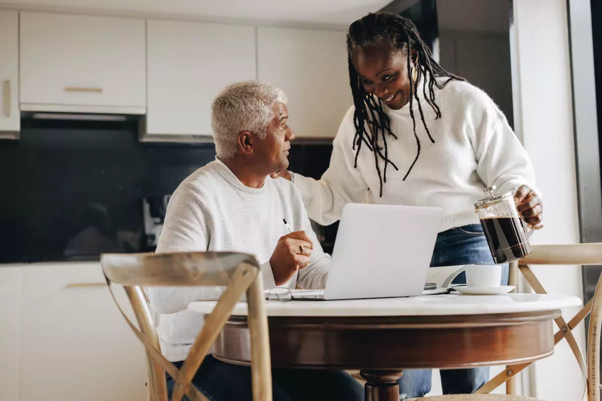 AdobeStock_512735660.jpeg Couple paying bills in the kitchen