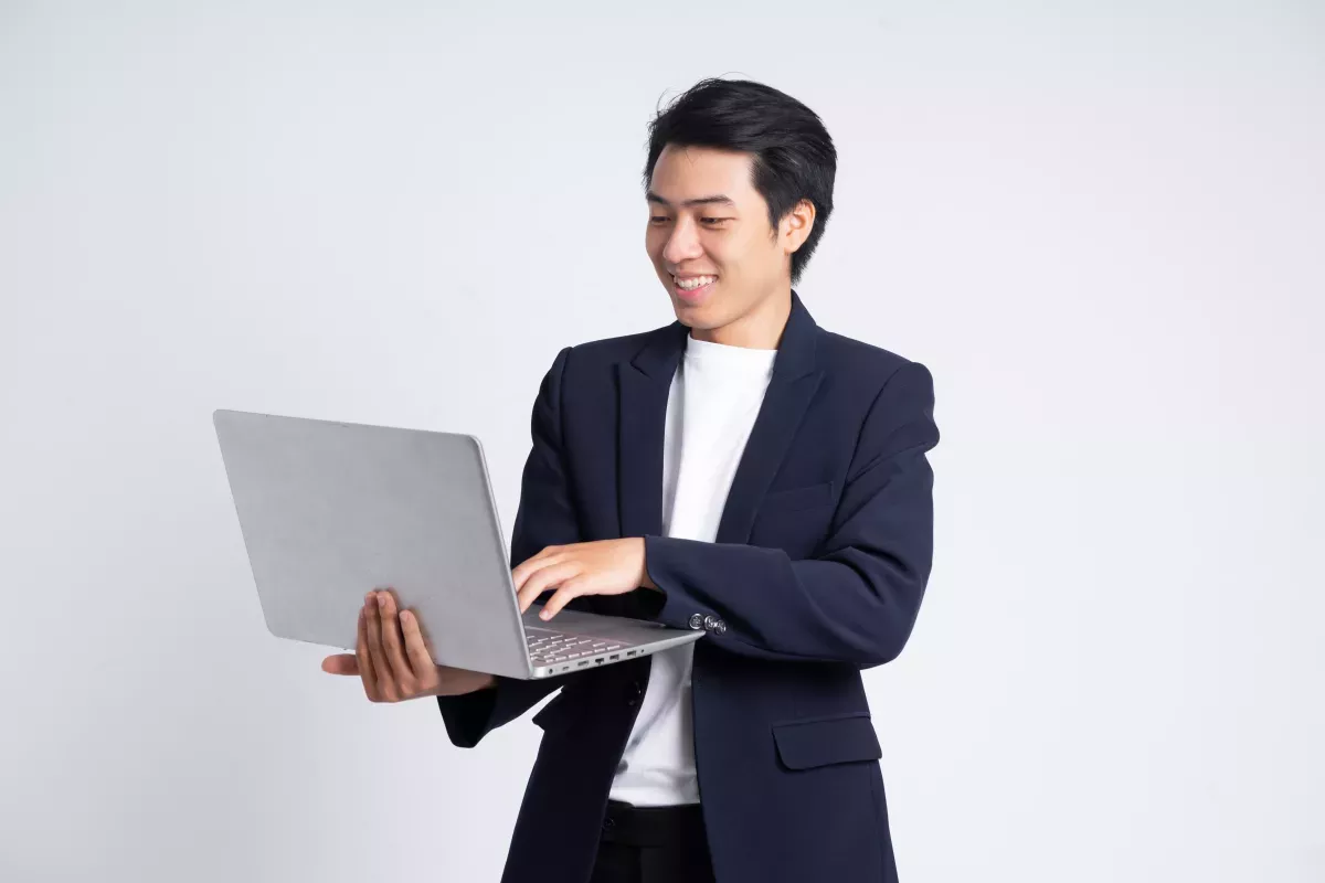AdobeStock_530121152.jpeg man holding laptop