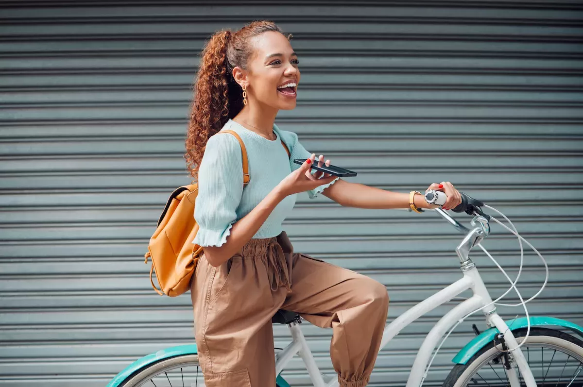 AdobeStock_537697244.jpeg Woman talking on the phone while riding a bike