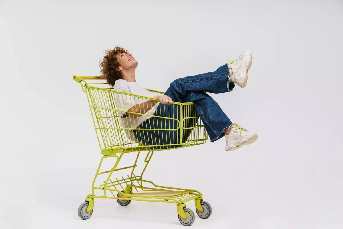 AdobeStock_550050674.jpeg Woman riding in a grocery cart