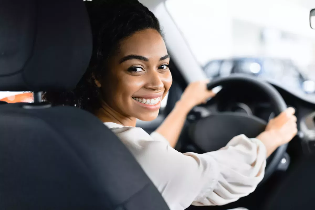 Adobe_323412938 excited woman test driving a new car