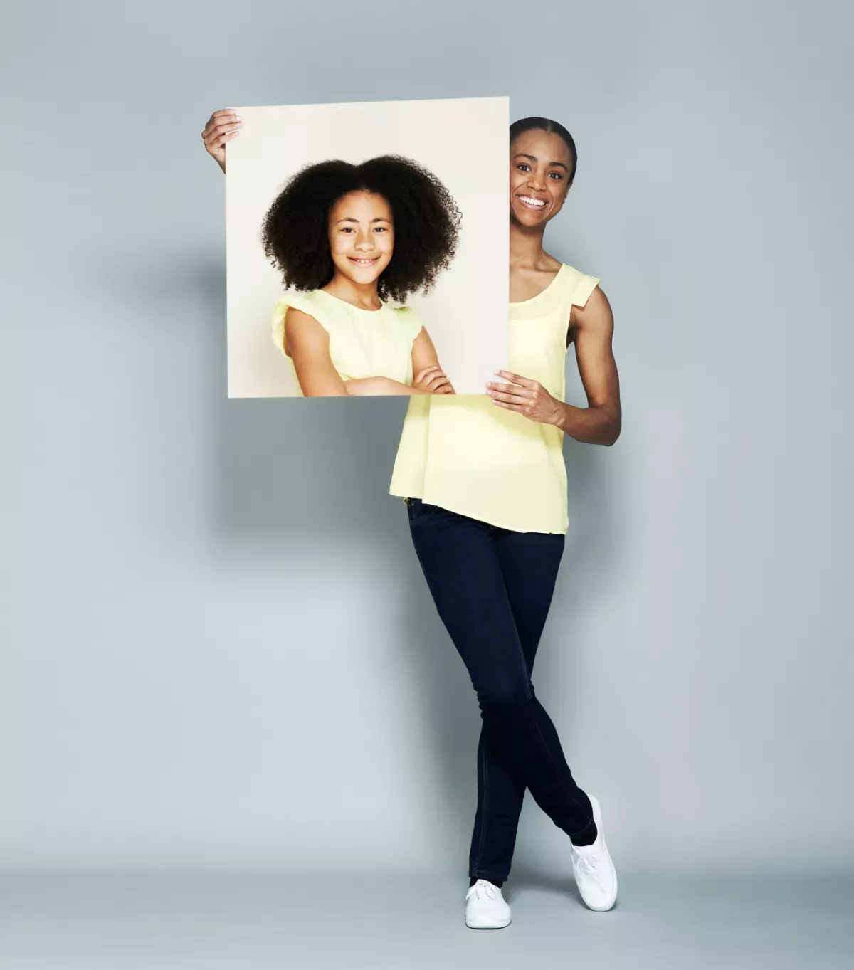 Feature generation.png Woman holding a picture of herself as a child