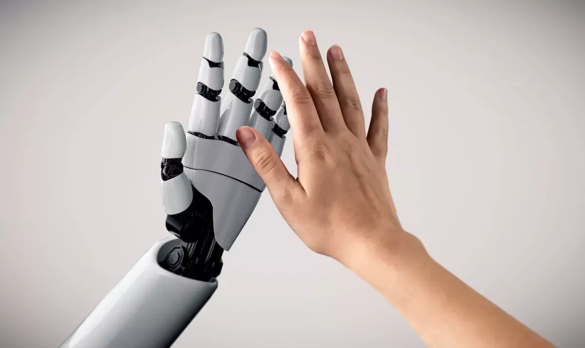 Robotic hand giving a human hand a high five