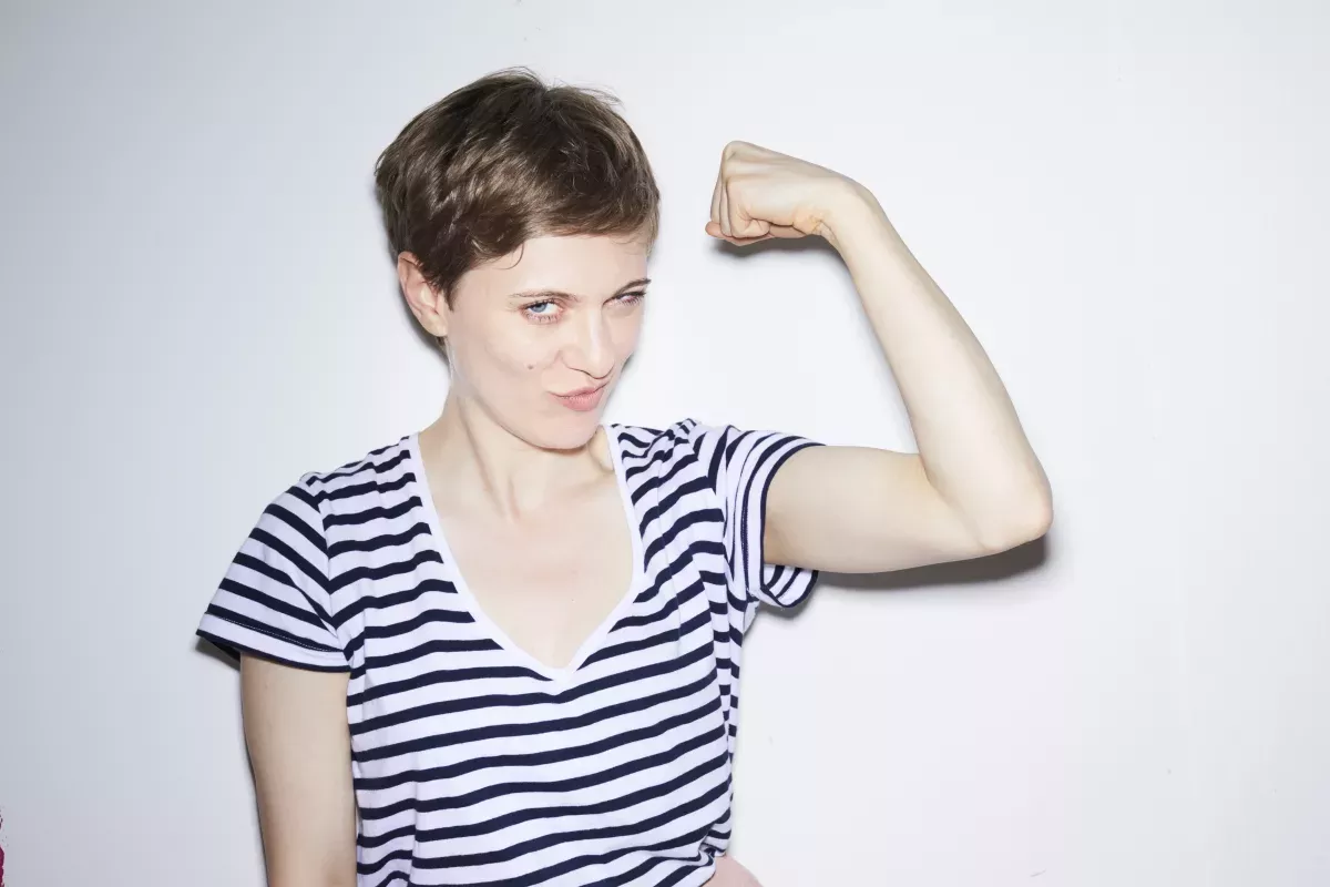 GettyImages-1011450638.jpg smiling woman flexing