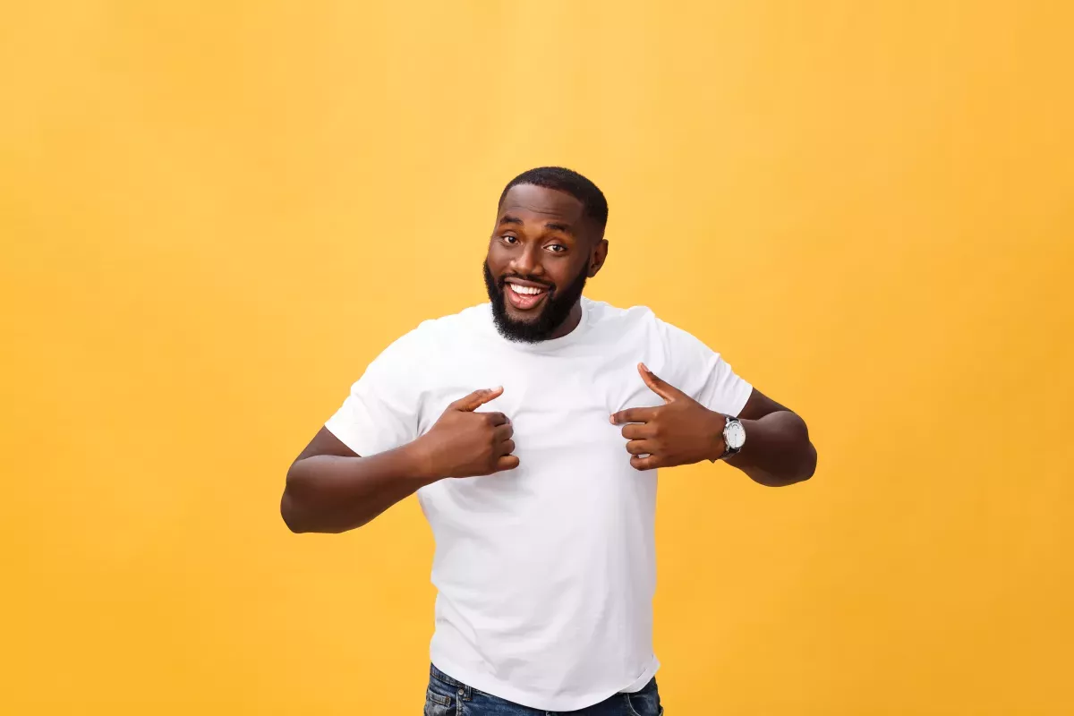 GettyImages-1319055470.jpg man standing in front of orange background