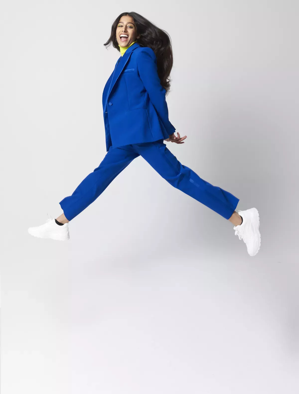 GettyImages-1355078925.jpg woman in business suit leaping